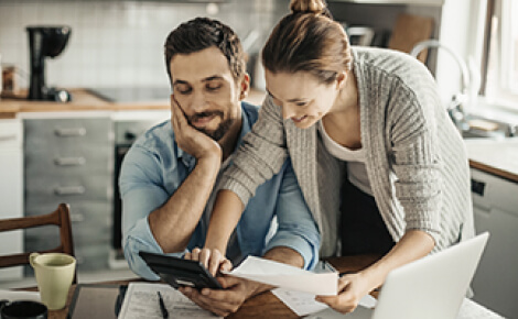 Couple looking over papers and a calculator