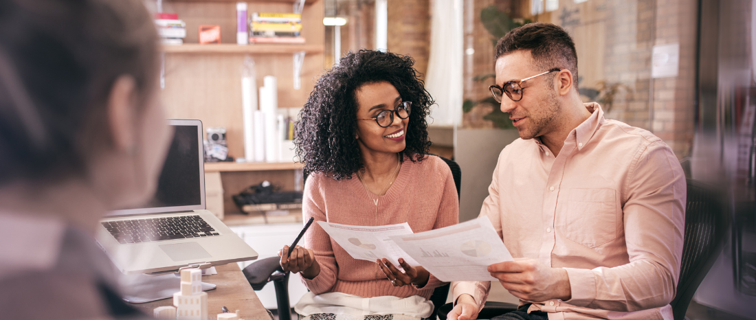 Couple in meeting reviewing documents
