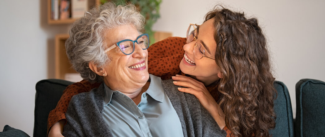 Young woman hugging older woman