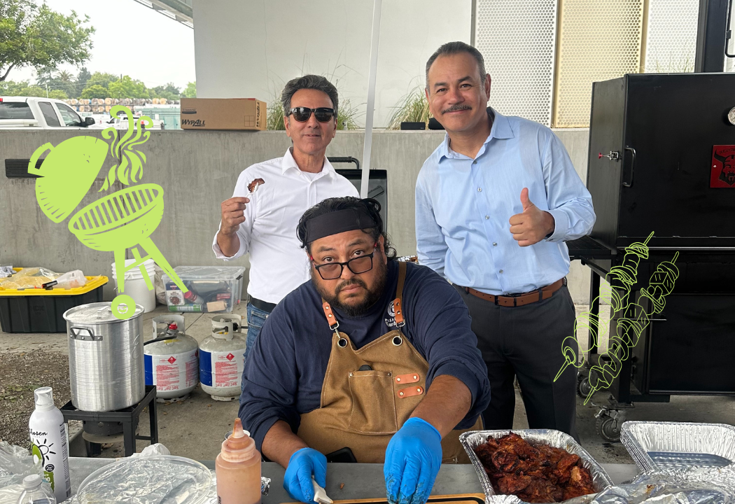 Three men at an outdoor BBQ cookout.